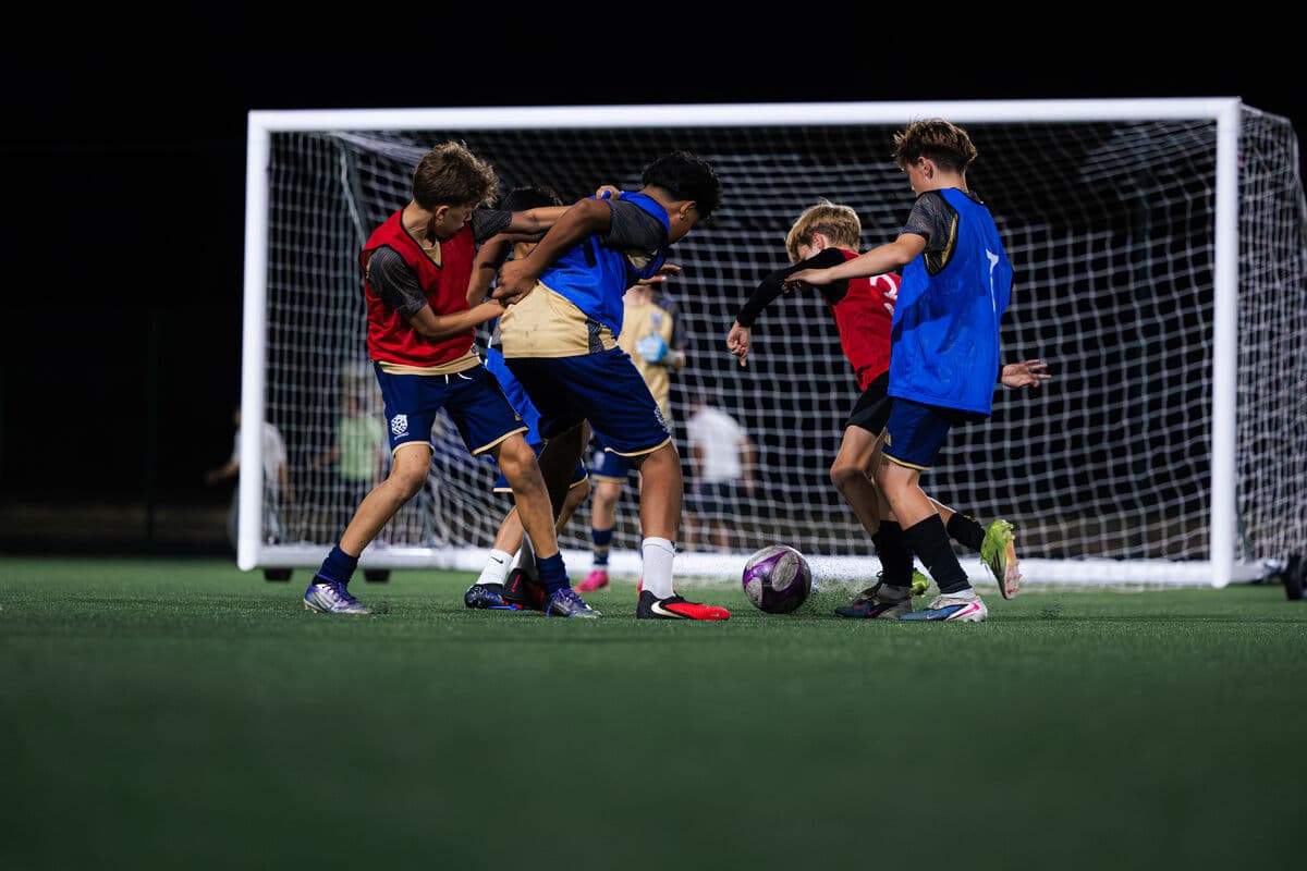 Players contesting the ball in a crowded goalmouth