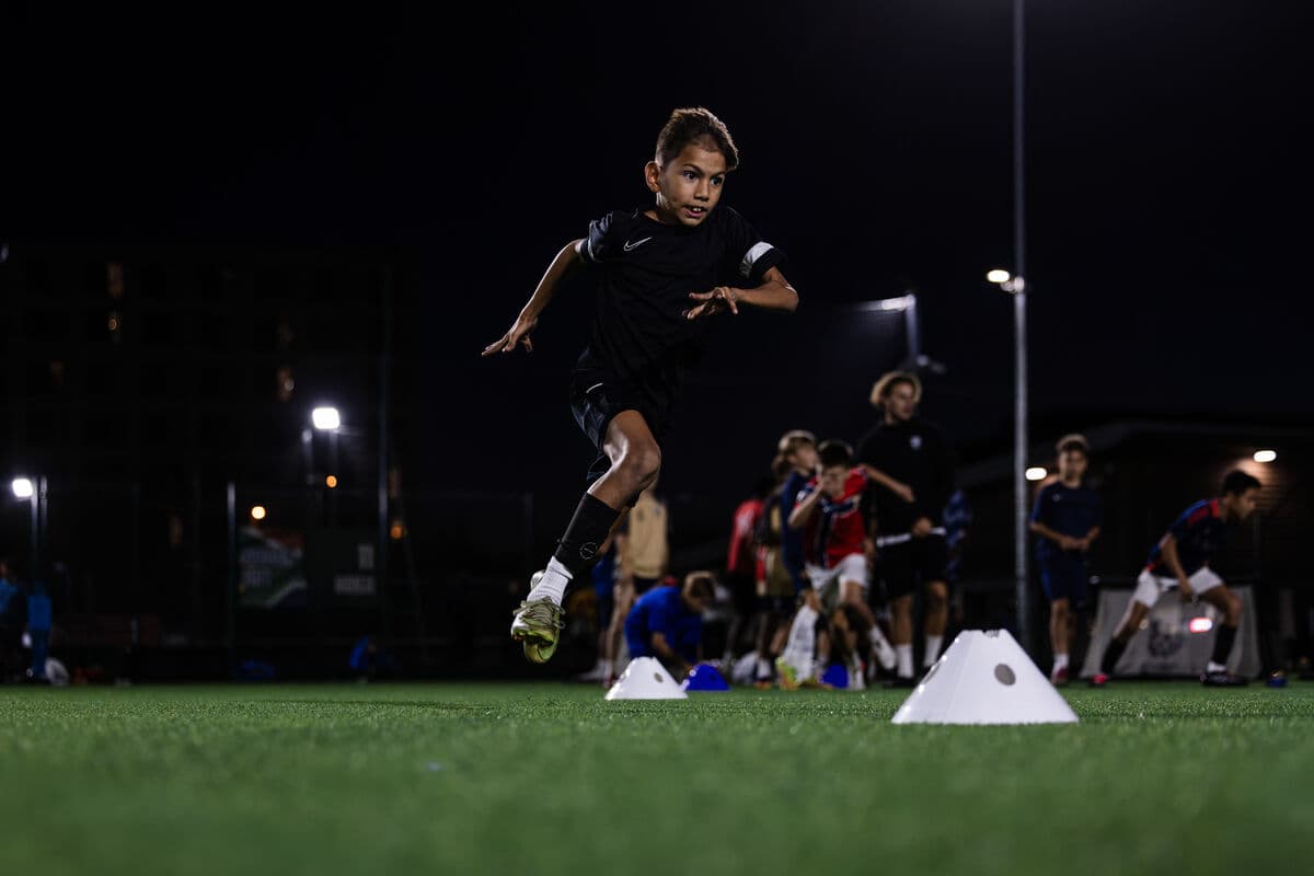 An E-PPRO player sprinting through an agility drill between cones
