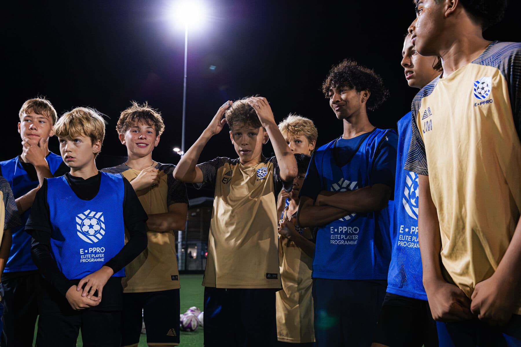 E-PPRO players gathered together listening to a coach