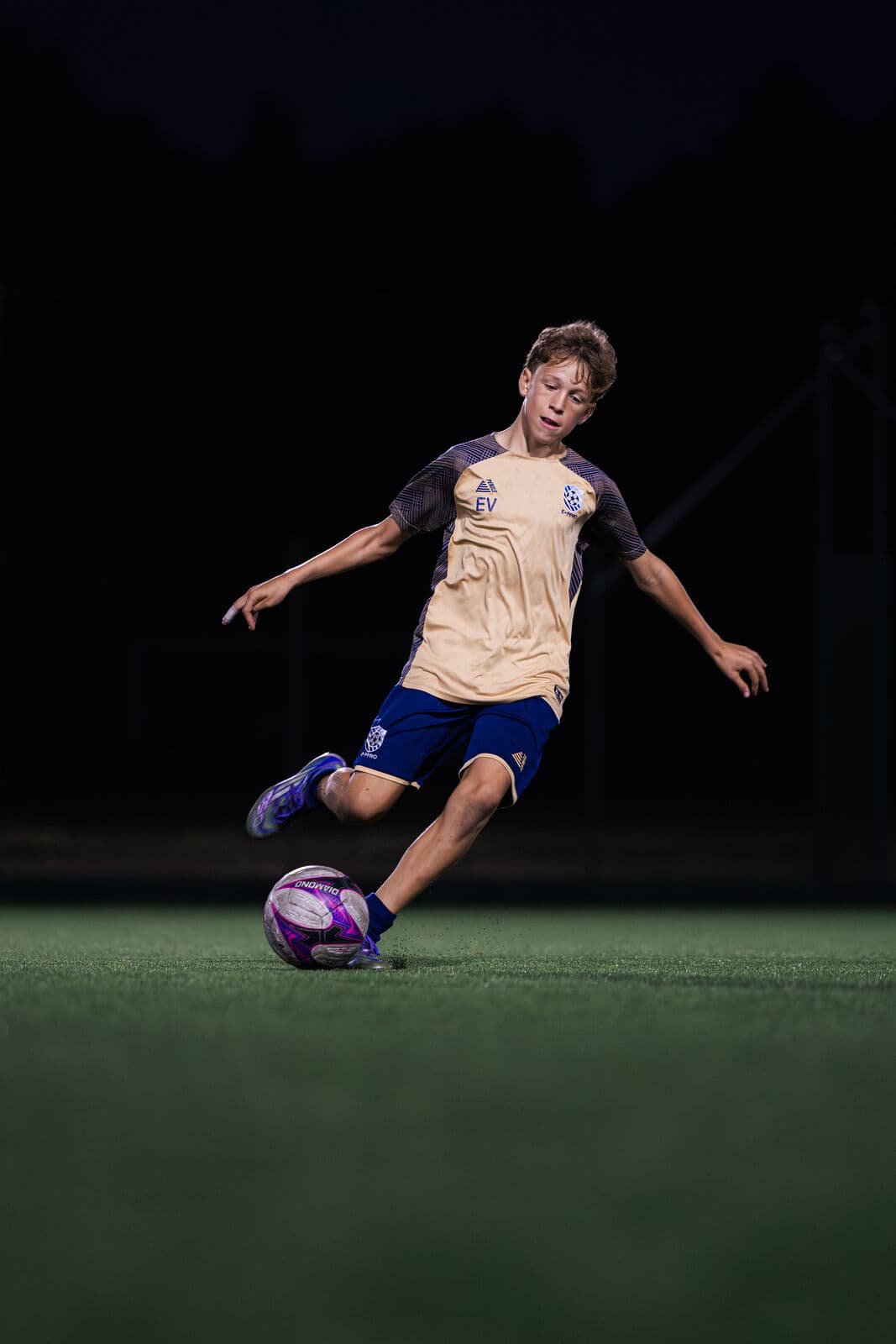 A young player striking the ball
