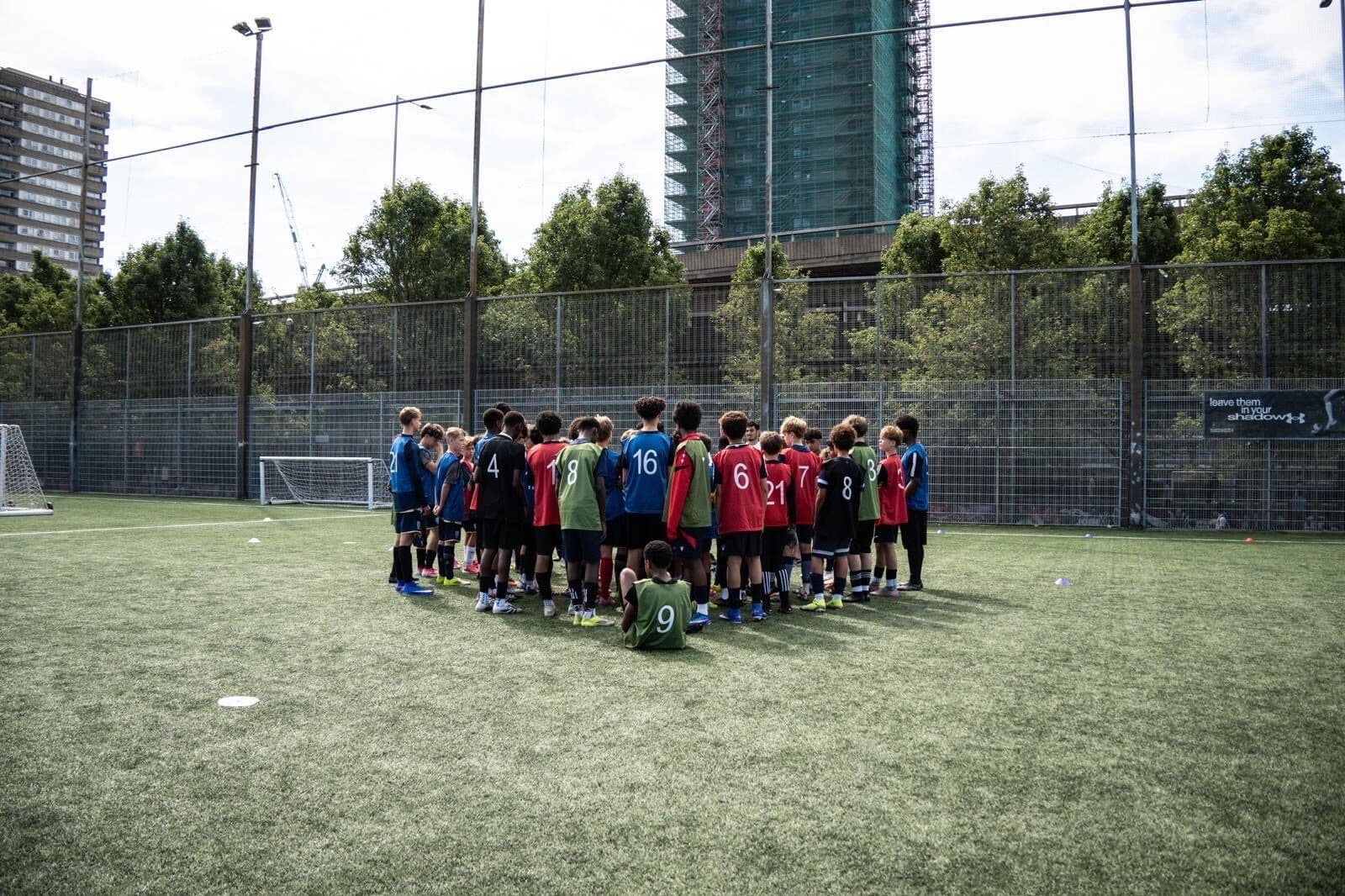 Players huddled around the coaches at E-PPRO's Talent ID Day at Westway