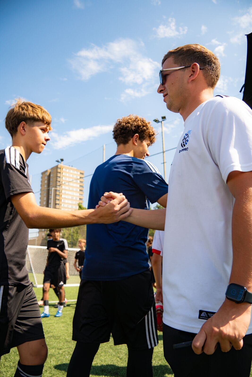 An E-PPRO coach shaking a player's hand at Westway