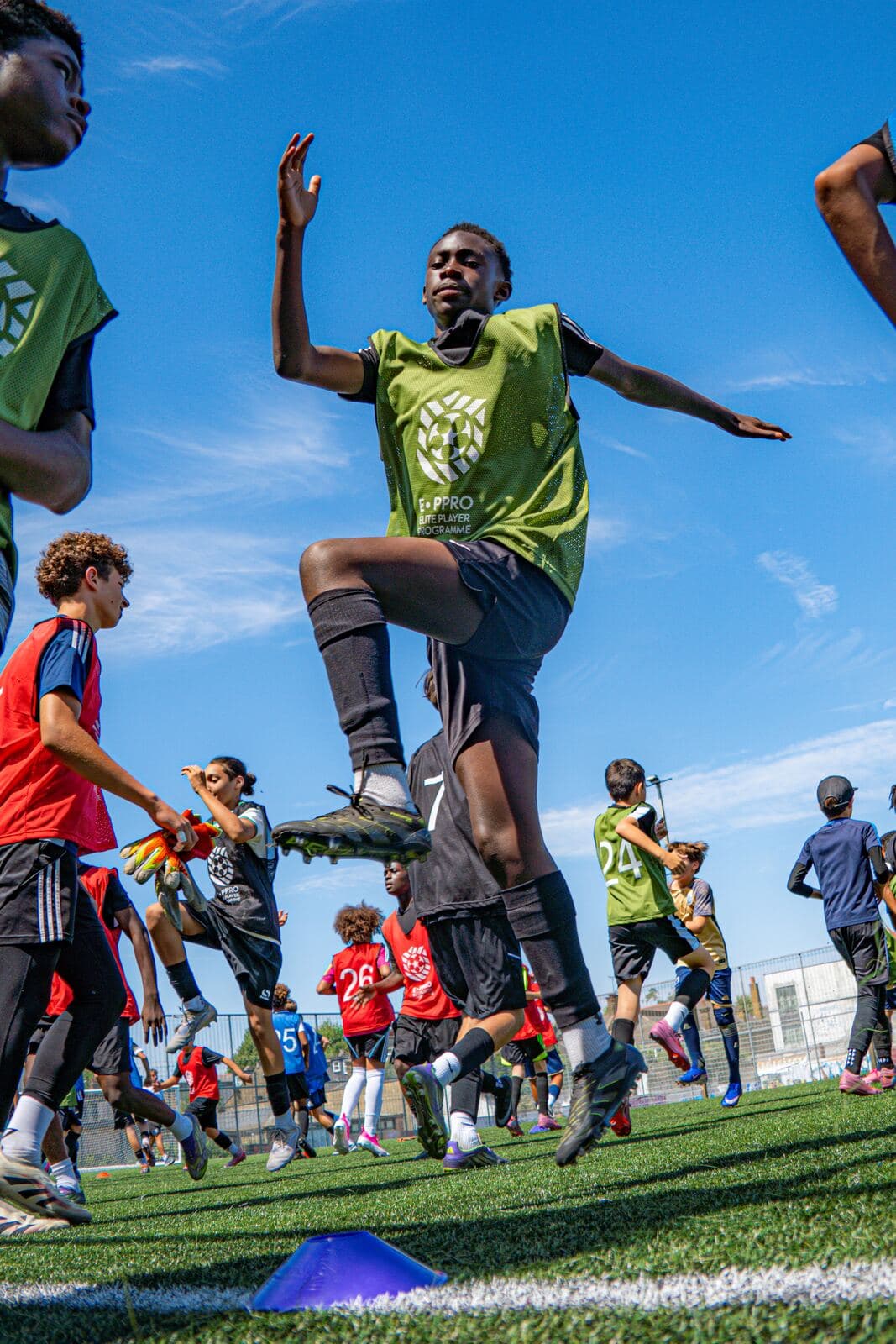 A player leaping during a warm-up drill at Westway