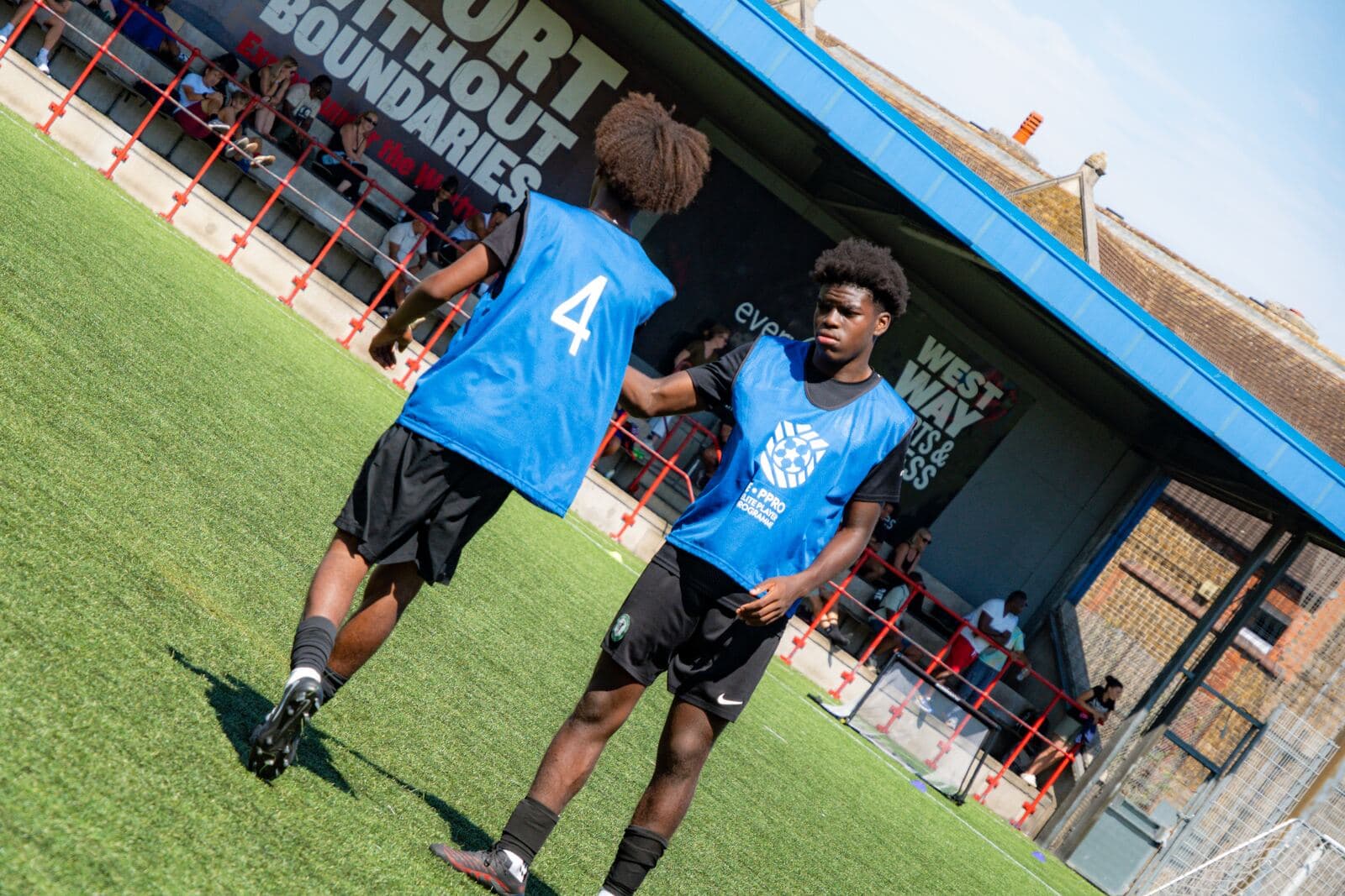 Players warming up in front of the Westway stand